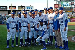 Men in baseball uniforms standing on a baseball field