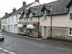 Street scene, showing shops and houses including a post office.