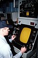A crewman monitors a mine detection and classification sonar console aboard the ocean minesweeper USS Conquest