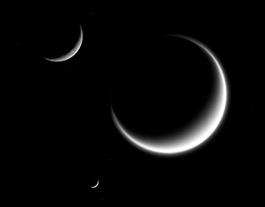 Mimas (smallest) together with Rhea and Titan in crescent shape, forming a triple crescent.[40]