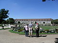 Three persons looking at the orangery in Ansbach