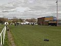 Cricket pitch end and cricket pavilion with changing rooms underneath.