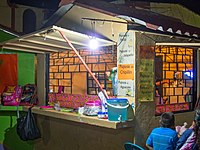 A pupusería in Santiago Texacuangos, El Salvador. Note the various pupusas advertised on the wall: chicken, jalapeño, chipilín, and avocado