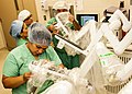 Image 59Medical personnel place sterilized covers on the arms of the daVinci Xi surgical system, a minimally-invasive robotic surgery system, at the William Beaumont Army Medical Center. (from History of medicine)