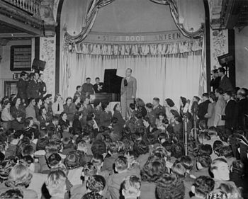 Bing Crosby sings to Allied troops at the opening of the London stage door canteen in Piccadilly, London, England; 31. August 1944