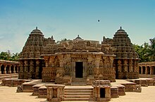 Brown temple on 5-step platform with 2 cone-topped side chambers