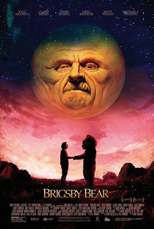 A man and a person in a bear costume shake hands below a large planetoid with a face.
