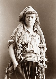 Photo of young man standing, wearing 18th-century fisherman's costume