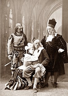 Photograph of three men and one woman in costume