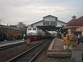 Kereta api Sembrani dan Kereta api Matarmaja di Stasiun Tegal dengan latar belakang Gunung Slamet