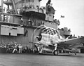 A Grumman F6F-3 Hellcat fighter makes condensation rings as it awaits the take-off flag aboard USS Yorktown (CV-10), 20 November 1943.