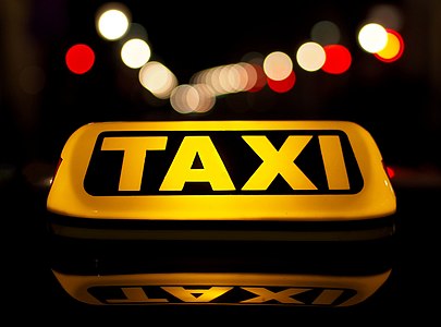 Taxi sign in night traffic, Ljubljana, Slovenia