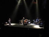 PJ Harvey and her band performing at the Royal Albert Hall