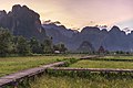 67 Wooden walkway leading to a hut with straw roof in front of karst mountains at sunset, Vang Vieng, Laos uploaded by Basile Morin, nominated by Basile Morin,  13,  0,  1