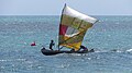 Kinder trainieren im Küstenauslegersegelboot vorm Wind Strand von Anako