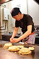 A man prepares okonomiyaki 料理人がお好み焼きを作る