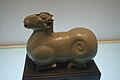 A Chinese Western Jin Dynasty (265-316 AD) celadon ceramic candle holder in the shape of a kneeling sheep.