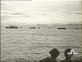 US and RAAF troops watch the allied convoy coming in for the landing near Aitape, 22 April 1944.