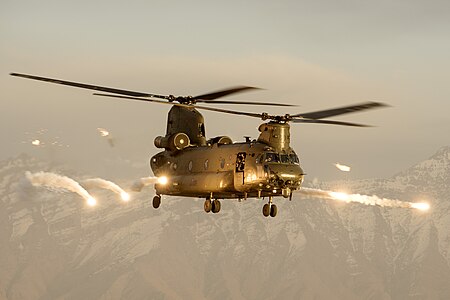 A Royal Air Force Chinook helicopter firing flares over Afghanistan