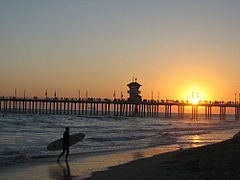 Huntington Beach City Pier with silhouette of surfer