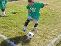 Kid playing football (soccer).