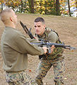 Two Marines trains with bayonets attached at M16A2s