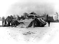 Tankmen of the U.S. First Army gather around a fire on the snow-covered ground near Eupen, opening their Christmas packages (12/30/44) -5th Armd. Regt