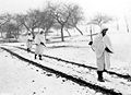 Three members of an American patrol cross a snow covered Luxembourg field on a scouting mission. White bedsheets camouflage them in the snow. Left to right: Sgt. James Storey, Newman, Ga.; Pvt. Frank A. Fox, Wilmington, Del., and Cpl. Dennis Lavanoha, Harrisville, N.Y. (30 Dec 1944). Lellig