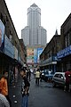 Large bank building behind older shops in Dalian