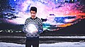 Young man holding a sphere moon model.