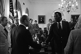 President Gerald R. Ford Greeting Rafer Johnson and Other Members of the President's Commission on Olympic Sports in the Cabinet Room - NARA - 45644201.jpg