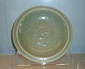 Celadon dish with applied dragon design. Longquan ware, Yuan Dynasty (1271-1368). On display at the Shanghai Museum in Shanghai, PRC.