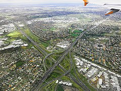The western suburbs of Melbourne and an interchange between Western Ring Road & Calder Freeway. Near the plane wing, you can see the Essendon Airport.