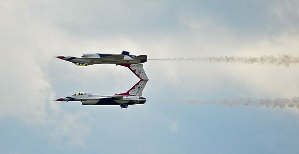 Two U.S. Air Force Thunderbird F-16 Fighting Falcons execute a precision acrobat technique at MacDill Air Force Base, Fla