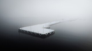 Floating pier in a wintery fog in Kõrgessaare harbor, Hiiumaa Rural Municipality, Estonia