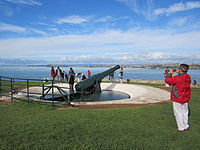 Tourists inspecting a disappearing gun at North Head, New Zealand