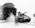 A French Army "Sherman" tank lands on a Normandy beach from USS LST-517, 2 August 1944.