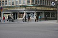 Place of Olof Palme's murder. Sveavägen-Tunnelgatan, Stockholm, Sweden. Picture taken from the southwest corner of the crossing of Sveavägen, Tunnelgatan and Olof Palmes gata. The exact place of the murder is where the three girls, to the right of the Kreatima sign, are standing. The killer ran into Tunnelgatan (between Kreatima and the T-sign). The shop was called Dekorima in 1986.