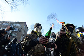 Masked and hooded protesters holding Molotov Cocktails seen during clashes in Ukraine, Kyiv. Events of February 18, 2014.jpg