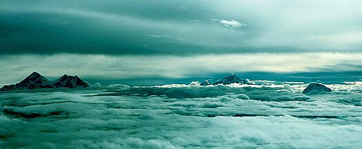 Everest with Lhotse, Makalu, and Chamlang penetrate above the clouds from left to right