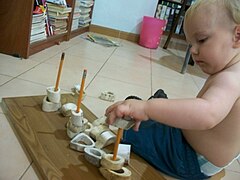 A child with improvised rings sorting learning activity.jpg