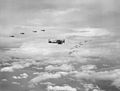 Aircraft of Carrier Air Group Five (CVG-5) in December 1943. In the center and to the left Grumman F6F-3 Hellcat fighters are visible.