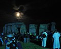 Druids watch the moon set beind the standing stones