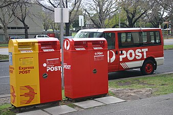 Australia, operator: Australia_Post Australia Post normal (red) & Express Delivery (yellow) post boxes in a heavy traffic area.