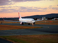 A Virgin Australia Boeing 737 taxiing at sunset