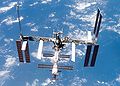 ISS viewed from Atlantis during fly-around maneuver backdropped by a blue and white Earth