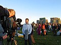 A TV reporter records a piece to camera