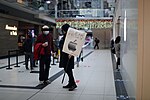 Thumbnail for File:Man with "Bleak Friday" sign talking to Apple Customer.jpg