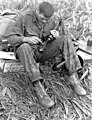 U.S. Army Soldier cleans his XM16E1 rifle during the Vietnam War in 1966.