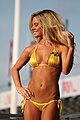 This model wears a yellow string bikini